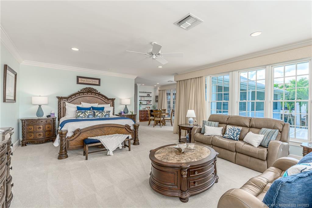 1455 Southeast Riverside Drive Stuart, FL 34996 - Photo 81 of 100 a bedroom with furniture and a large window