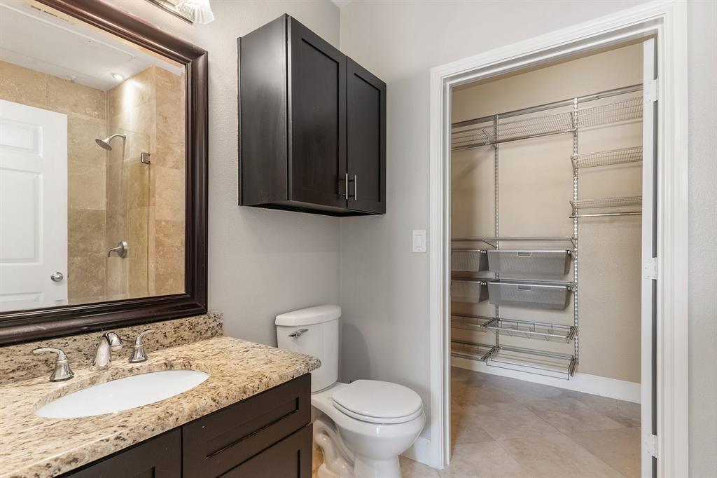 3102 Kings Road, Unit 1106 Dallas, TX 75219 - Photo 13 of 20 a bathroom with a granite countertop sink a toilet and a mirror