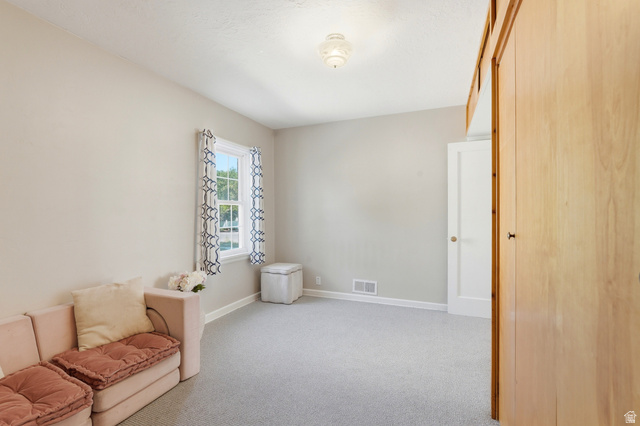 270 East 700 North Logan, UT 84321 - Photo 13 of 42 Light-filled interior featuring neutral wall tones and light-colored carpet flooring