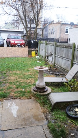 2441 West Haddon Avenue Chicago, IL 60622 - Photo 9 of 10 a view of a backyard with sitting area and fire pit