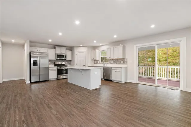 a kitchen with a stove top oven and refrigerator