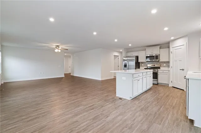 a view of kitchen with granite countertop cabinets and wooden floor