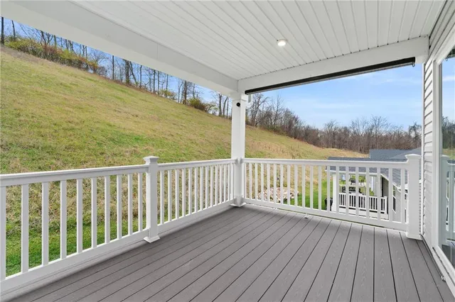 a view of a house next to a yard with big trees