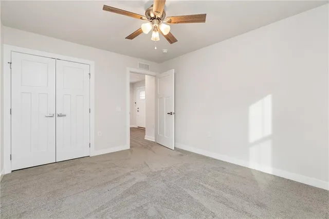 an empty room with a ceiling fan and a ceiling fan