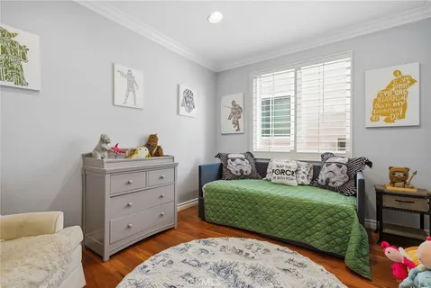 a bedroom with furniture and a wooden floor