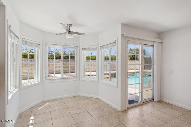 861 Dara Street Camarillo, CA 93010 - Photo 17 of 42 an empty room with chandelier fan and windows