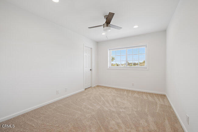 861 Dara Street Camarillo, CA 93010 - Photo 29 of 42 an empty room with a ceiling fan and windows