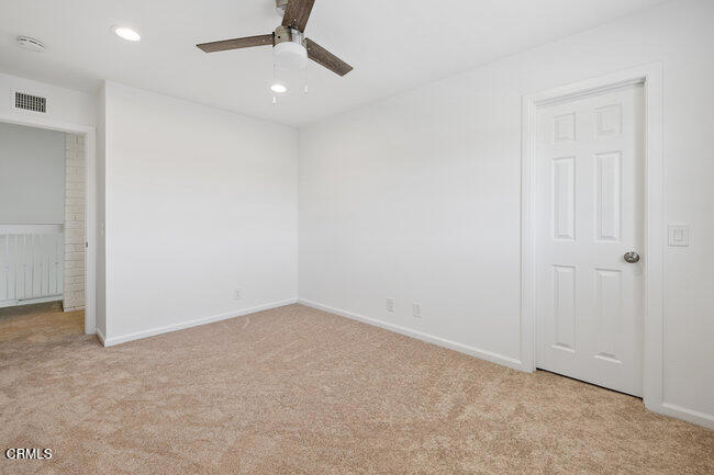 861 Dara Street Camarillo, CA 93010 - Photo 30 of 42 an empty room with a ceiling fan and carpet