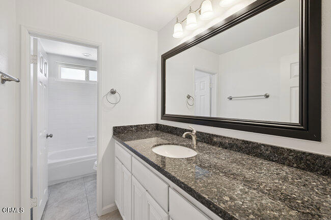 861 Dara Street Camarillo, CA 93010 - Photo 34 of 42 a bathroom with a granite countertop sink and a mirror
