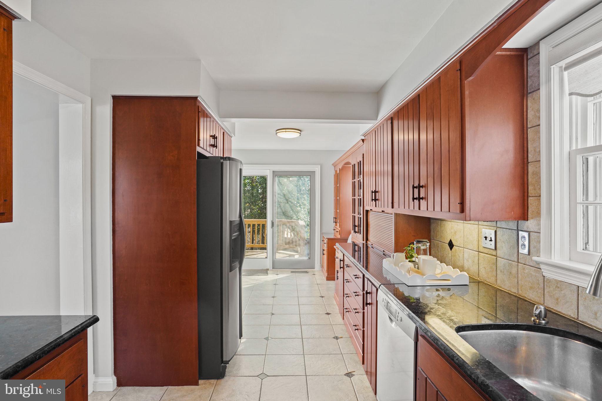 406 West Braddock Road Alexandria, VA 22302 - Photo 13 of 56 a kitchen with a sink stove and cabinets