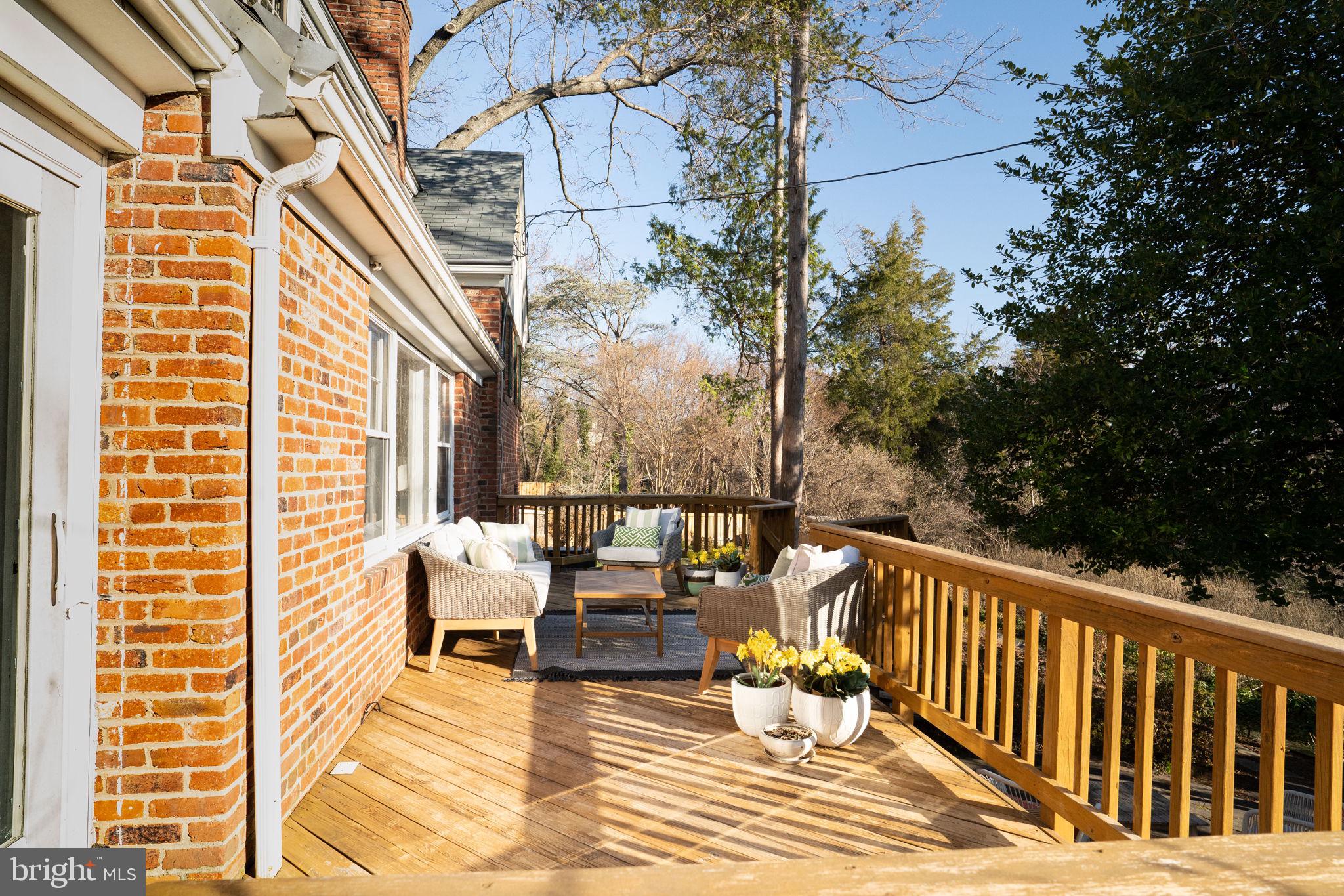 406 West Braddock Road Alexandria, VA 22302 - Photo 35 of 56 a balcony with wooden floor and outdoor seating