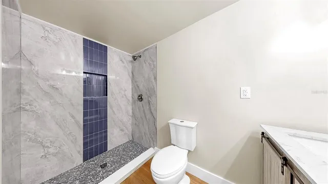 a white toilet sitting next to a bathroom sink