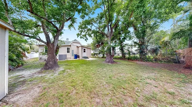 a white house that has a tree in front of it