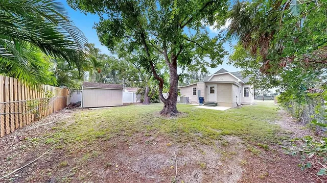 a front view of house with yard and trees