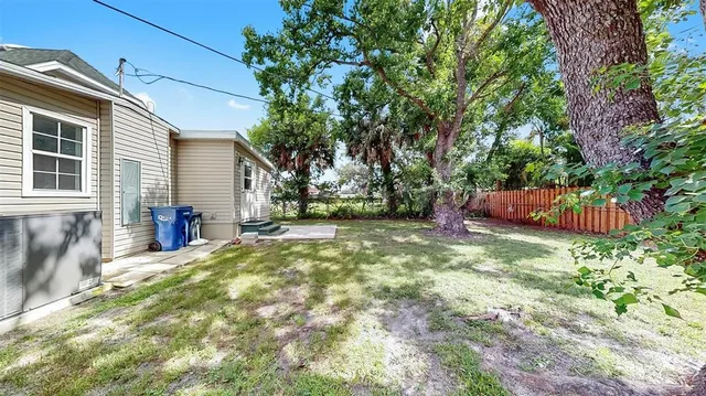 a view of a house with backyard and sitting area