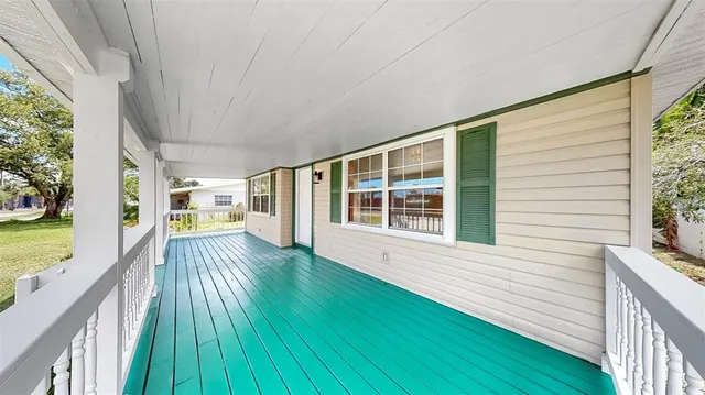 a view of a house with a wooden deck