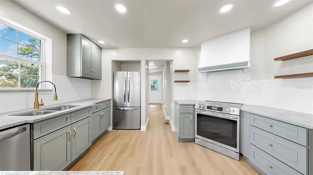 a kitchen with a stove a sink and a refrigerator