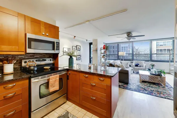 a kitchen with stainless steel appliances granite countertop a sink and cabinets