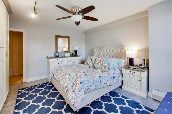 a bed room with a bed and a mirror