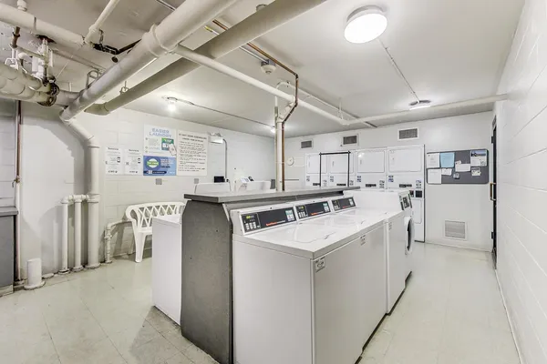 a kitchen with a stove cabinets and chairs
