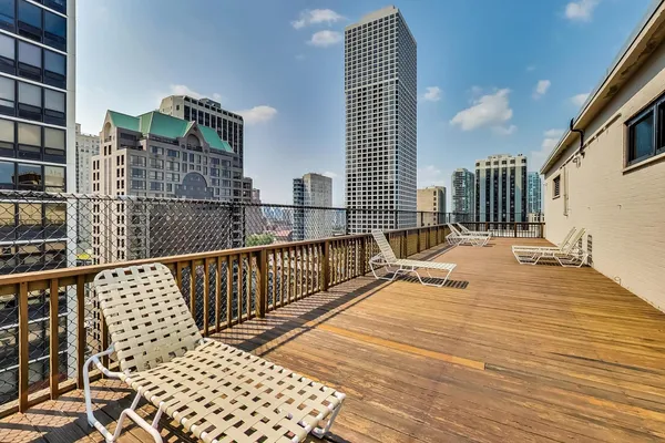 a balcony with wooden floor and furniture