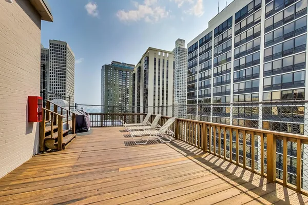 a view of balcony with wooden floor and fence