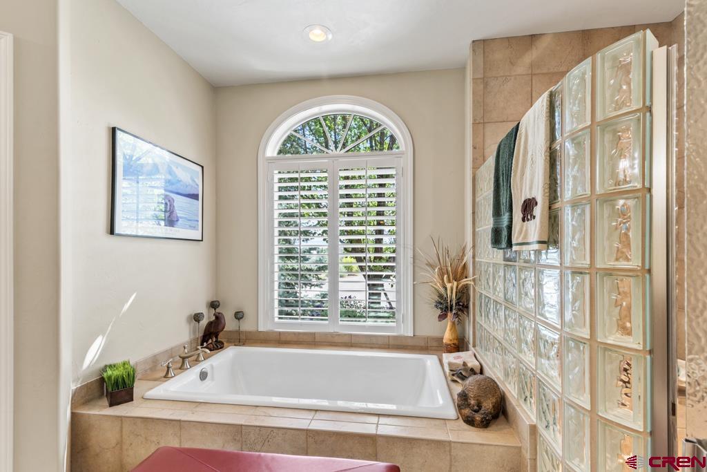 15103 6260th Road Montrose, CO 81403 - Photo 24 of 45 a bath tub sitting in a bathroom next to a window