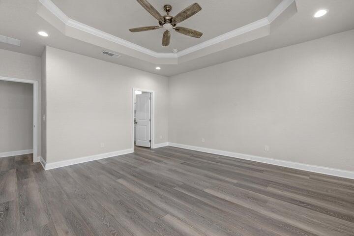 709 Northwest Lovejoy Road Fort Walton Beach, FL 32548 - Photo 4 of 4 an empty room with wooden floor fan and windows