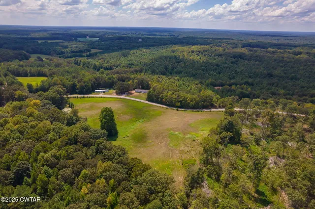 a view of a green yard with an outdoor seating
