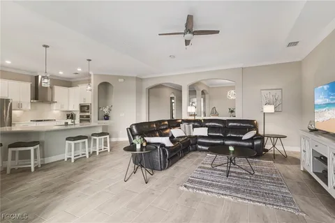 a living room with furniture a fireplace and kitchen view