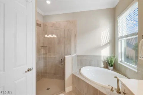 a bathroom with a tub sink and window