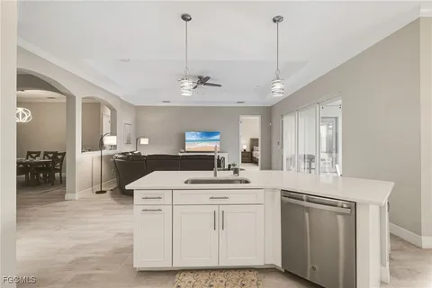 a kitchen with a sink stove and cabinets
