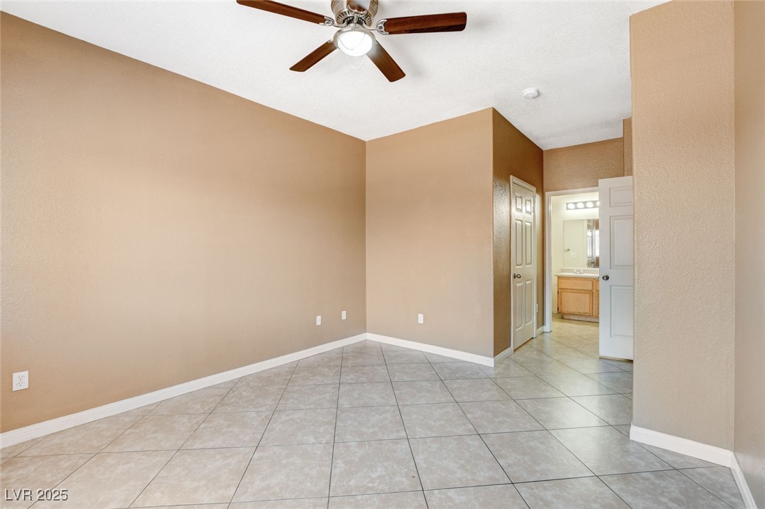 4730 East Craig Road, Unit 1005 Las Vegas, NV 89115 - Photo 28 of 45 Empty room featuring a ceiling fan and light tile patterned floors