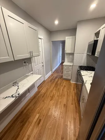 a spacious bathroom with a double vanity sink and a large mirror
