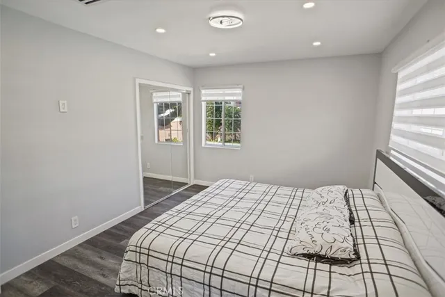 a bedroom with a large bed and a window
