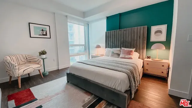 a bedroom with a bed couch and a window