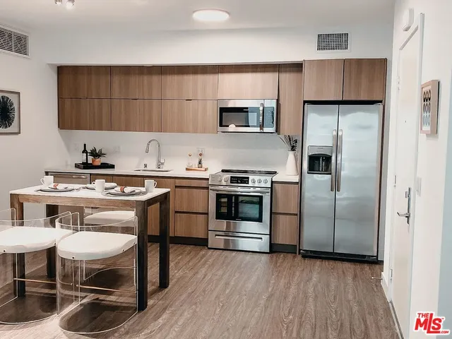 a kitchen with a sink cabinets and stainless steel appliances