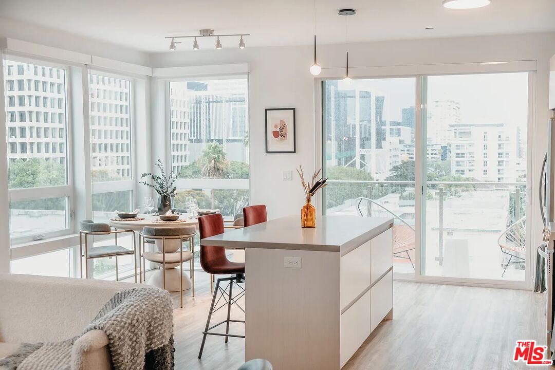 700 South Manhattan Place, Unit 513 Los Angeles, CA 90005 - Photo 5 of 9 a living room with furniture and a large window