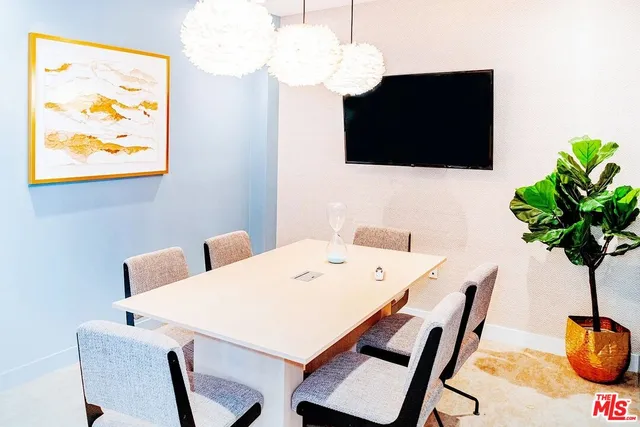 a dining room with furniture and a flat screen tv