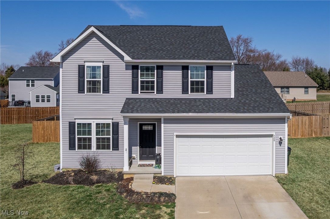 528 Oliver Way Rittman, OH 44270 - Photo 1 of 32 Traditional-style home featuring a front lawn, concrete driveway, fence, and roof with shingles