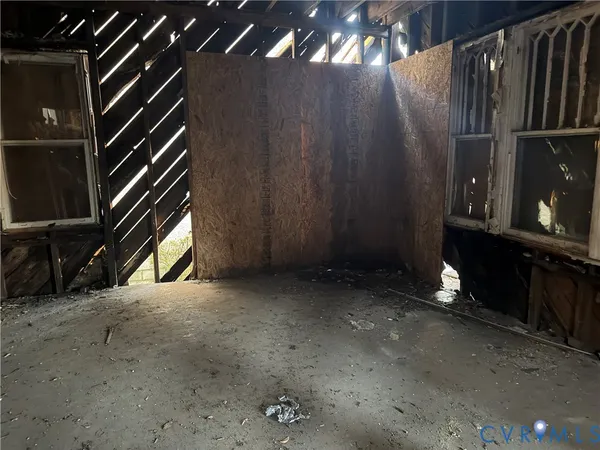 a view of an empty room and wooden floor