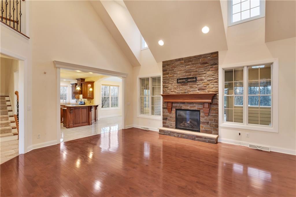 116 James Drive Beaver, PA 15009 - Photo 9 of 44 an empty room with wooden floor fireplace and windows