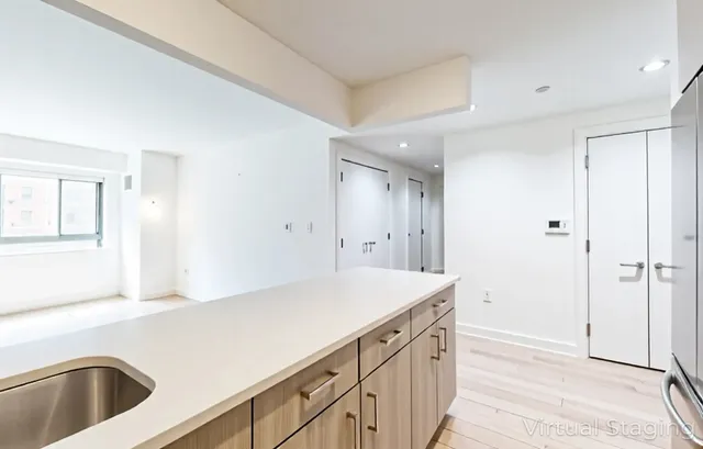 a kitchen with a refrigerator and a sink
