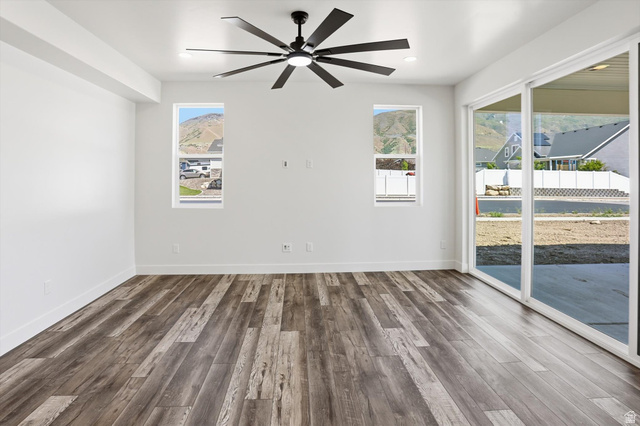 1315 West 3200 South, Unit 17 Perry, UT 84302 - Photo 9 of 58 Spacious room featuring wood-finish flooring, a contemporary ceiling fan, and recessed lighting