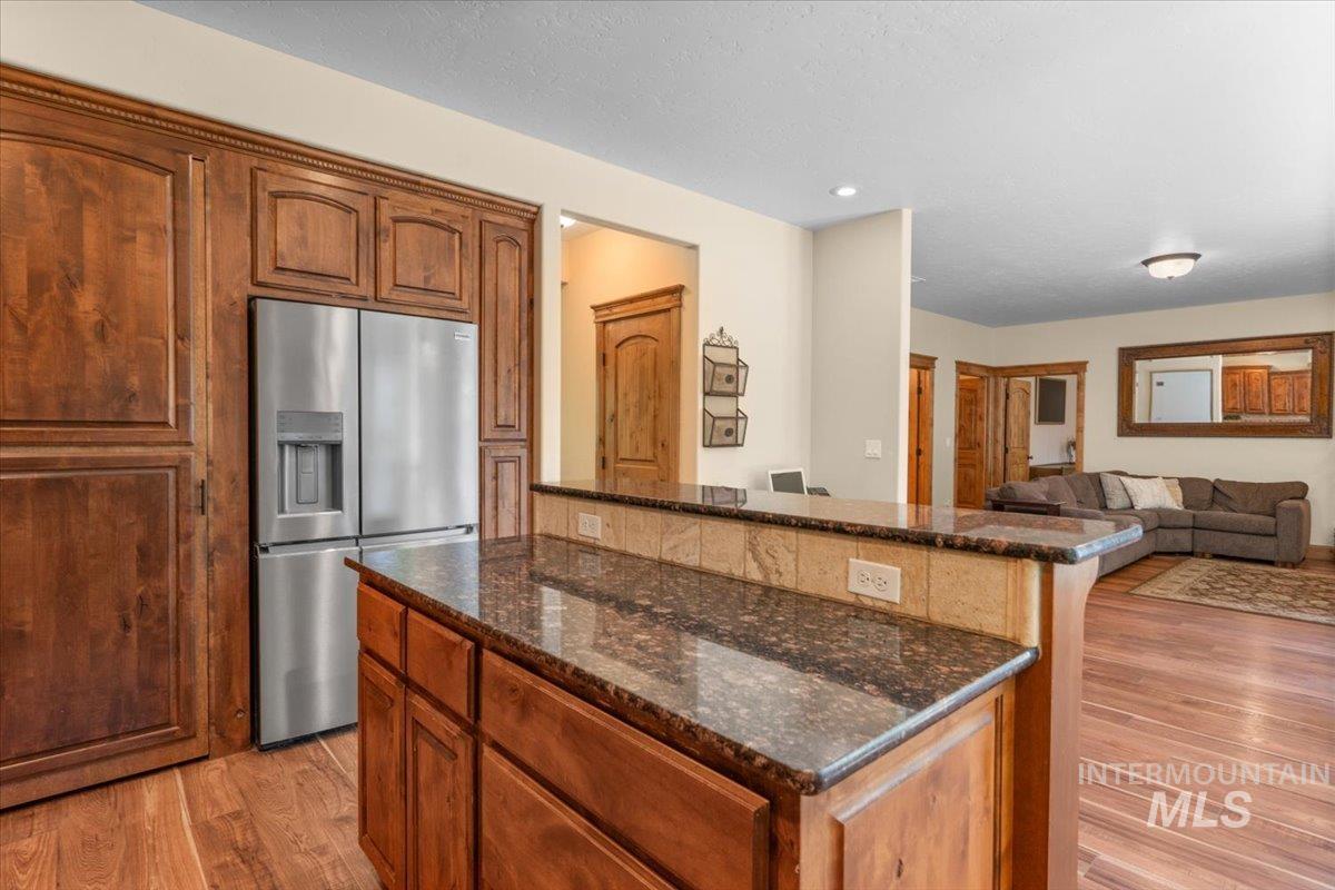 4154 North Tipton Avenue Meridian, ID 83646 - Photo 13 of 50 Kitchen island featuring a granite countertop and stone tile backsplash