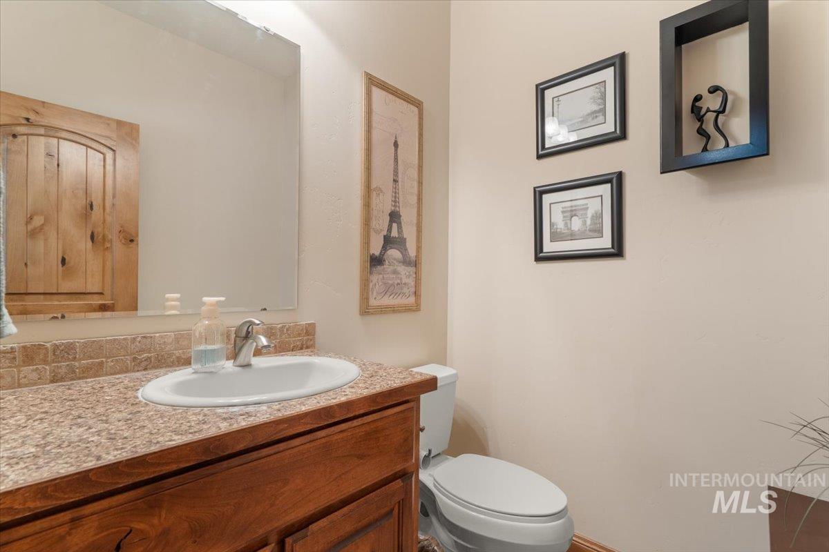 4154 North Tipton Avenue Meridian, ID 83646 - Photo 19 of 50 Bathroom vanity featuring a light-colored countertop, an oval undermount sink, and a single-handle faucet
