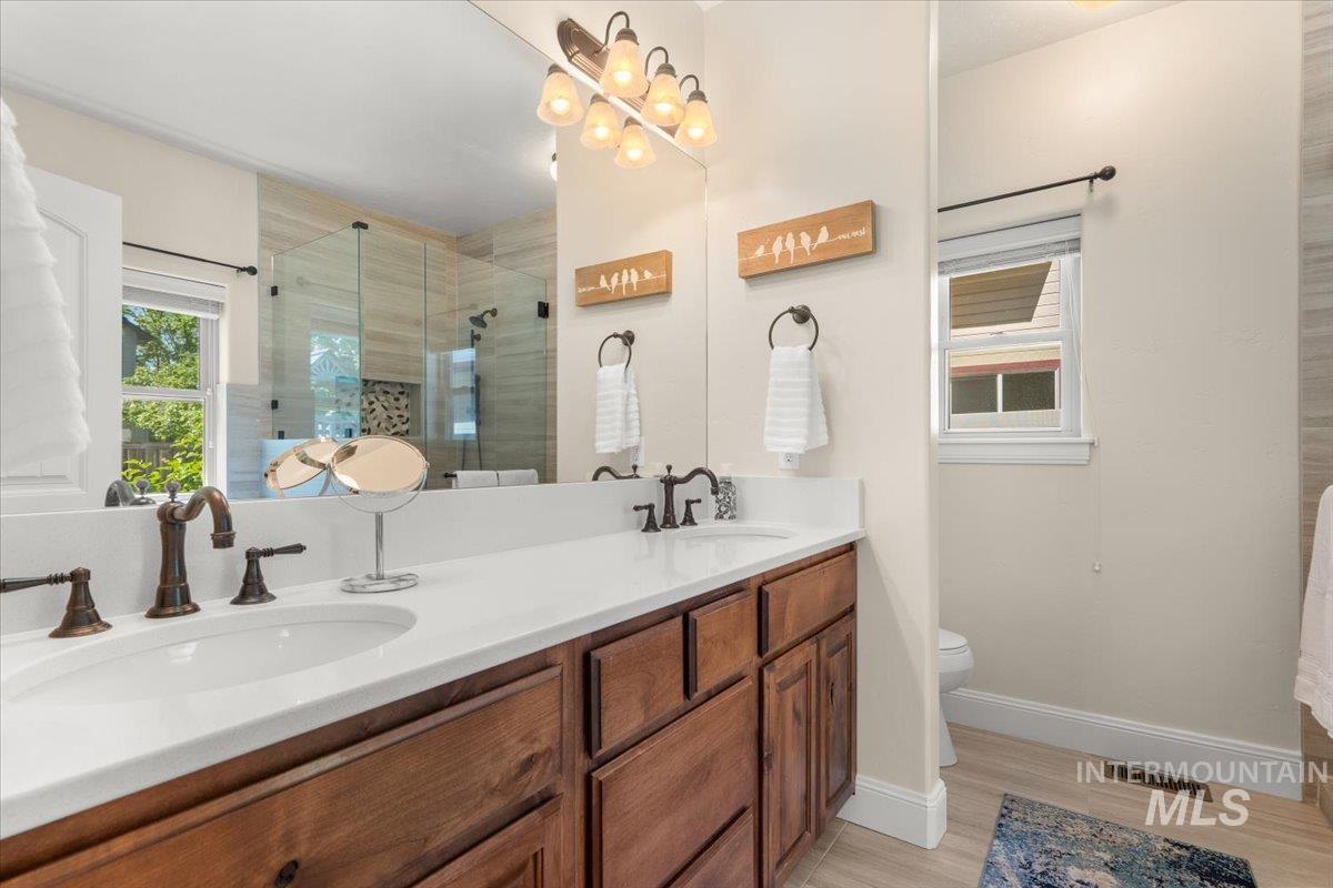 4154 North Tipton Avenue Meridian, ID 83646 - Photo 24 of 50 Dual vanity with wood cabinetry and white countertops