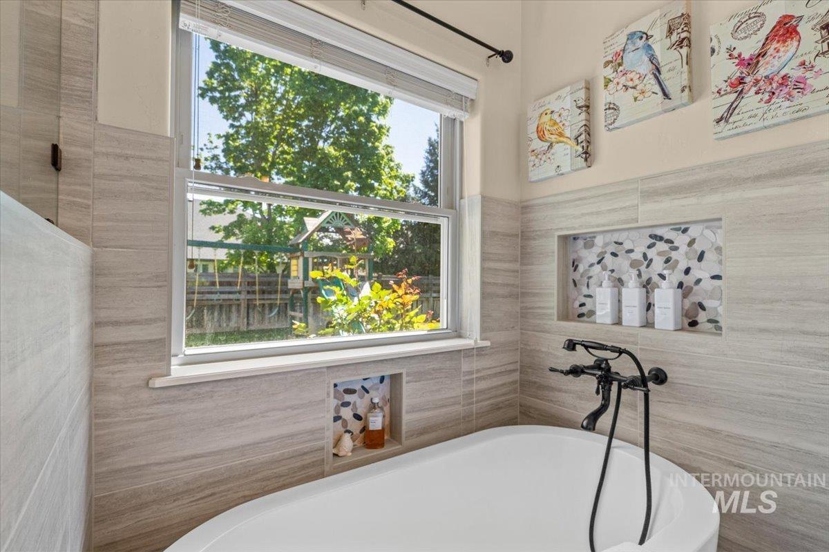 4154 North Tipton Avenue Meridian, ID 83646 - Photo 26 of 50 Freestanding soaking tub with a wall-mounted matte black faucet