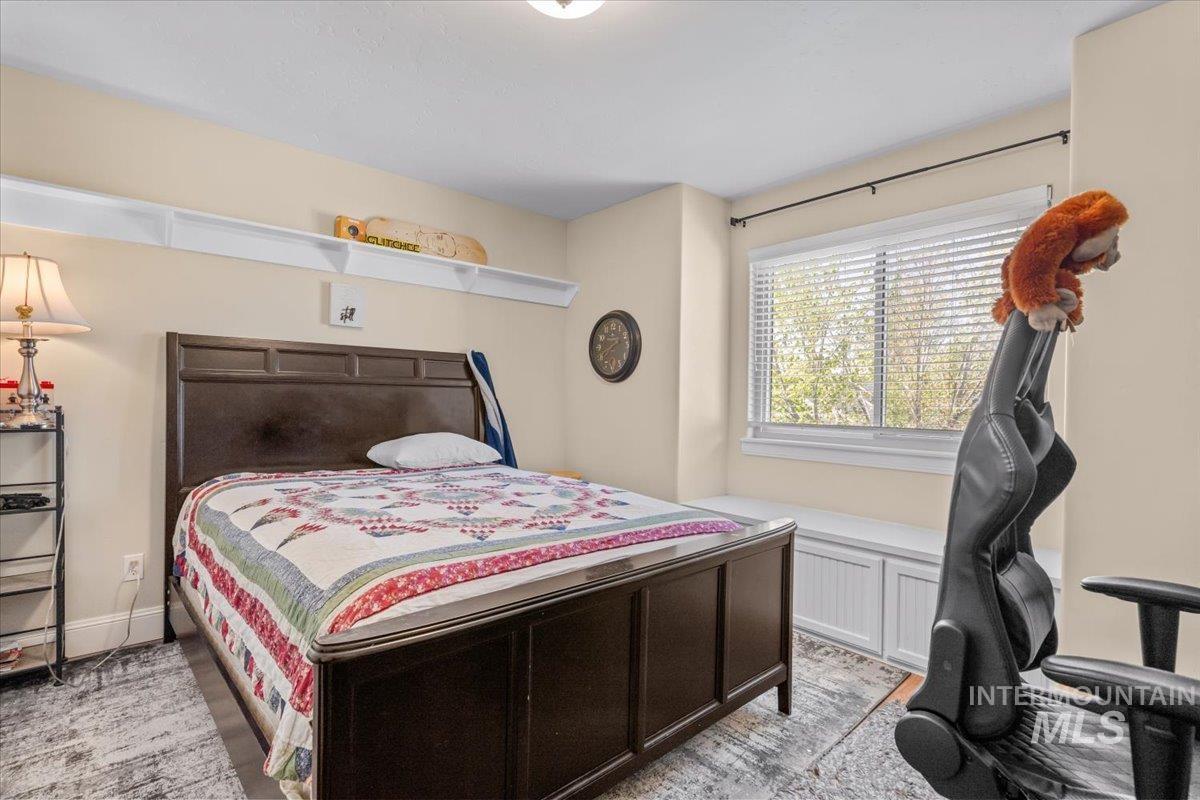 4154 North Tipton Avenue Meridian, ID 83646 - Photo 31 of 50 Bedroom featuring a large window, built-in window seat with storage, wall-mounted shelving, and light neutral wall tones