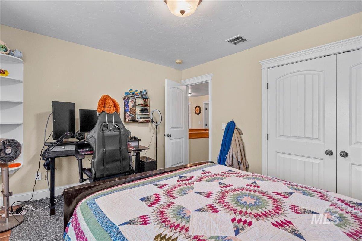 4154 North Tipton Avenue Meridian, ID 83646 - Photo 32 of 50 Bedroom featuring light-colored walls and a textured ceiling